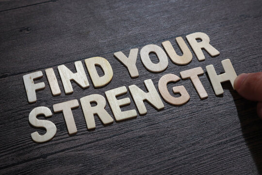 Find your strength, text words typography written with wooden letter on black background, life and business motivational inspirational