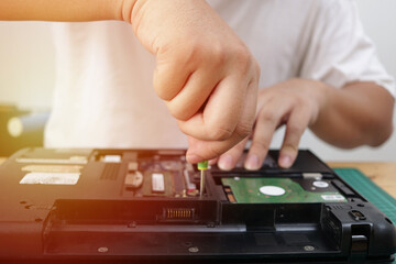 Close up of technician engineer trying to repairing broken laptop. Computer repairs and upgrade