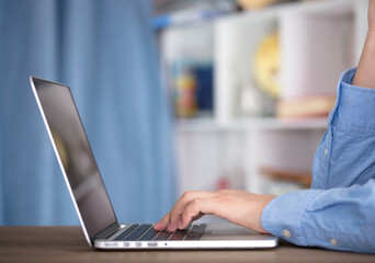 Man using laptop to work indoors