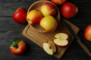 Board with tasty red apples on wooden table
