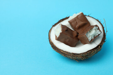 Coconut with candy bars on blue background