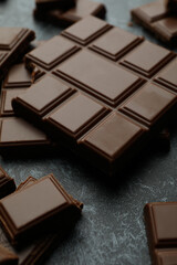 Tasty chocolate bars on black smokey background