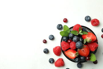 Bowl with berry mix on white background