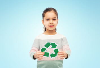 eco living, environment and sustainability concept - smiling girl holding green recycling sign over...