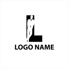 presentable man in a suit is leaning against the letter L negative space