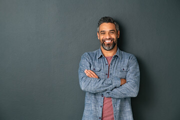 Smiling mixed race mature man on grey background