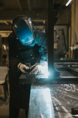 Manual worker welder on his job. People at heavy industry work.