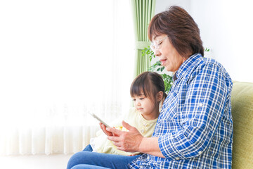 おばあちゃんとスマホを使う子供
