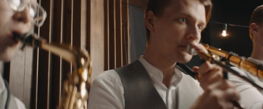 HANHDHELD CU Portrait of jazz band members playing brass instruments in recording studio during rehearsal. Shot on ARRI Alexa Mini with 2x anamorphic lens
