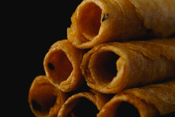 Tong Muan or Thai rolled wafer with dark background. Close up of Thai dessert.  