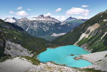 A beautiful glacial lake in Canada. The turquoise Joffre Lake is surrounded by the Rainforest. Mountain peaks in the background. Joffre Lakes Provincial Park. British Columbia, Canada.