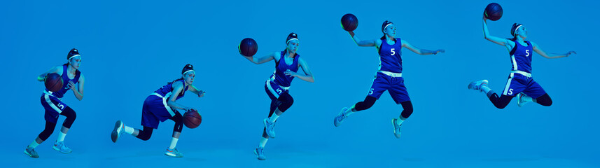Fototapeta na wymiar Flying. Beautiful female basketball player in motion and action in neon light on blue background. Concept of healthy lifestyle, professional sport, hobby.