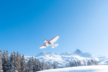Fototapeta na wymiar Propeller airplane in mountain winter landscape