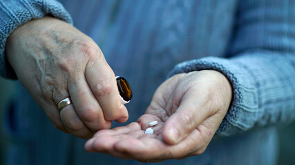 Pills in a elderly woman hands