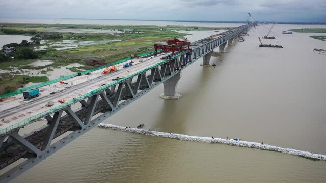 Aerial view of a building site while assembling the Padma bridge, the longest rail and highway bridge in Bangladesh crossing the Padma river, Zajira, Dhaka, Bangladesh.