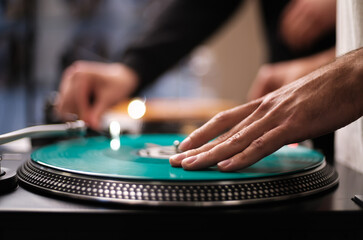 Hand of hip hop dj scratching vinyl record on turntables. Professional disc jockey scratches...