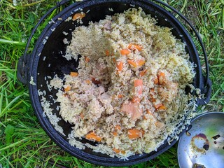 pilaf in a cauldron during the daytime in summer.