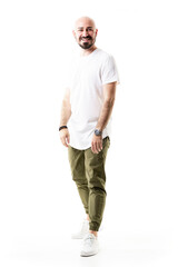 Naklejka premium Smiling cheerful young bald bearded man in olive green chino pants. Full body length isolated on white background