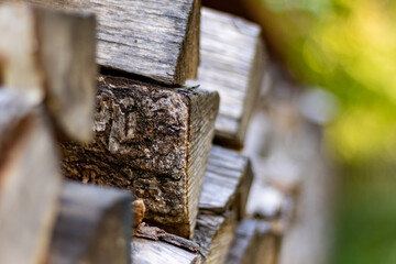 Pile of chopped fire wood against green background, closeup and selective focus
