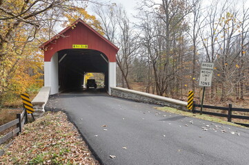 Red and White Wooden Covered Bridge in Daylight