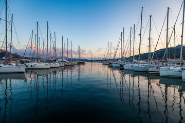 Marina yacht club on the European island of Sardinia at sunset - obrazy, fototapety, plakaty