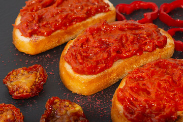 Homemade bruschetta with red pesto sauce