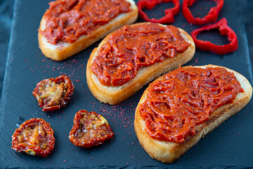 Homemade bruschetta with red pesto sauce