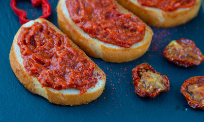 Homemade bruschetta with red pesto sauce