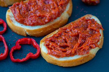 Homemade bruschetta with red pesto sauce