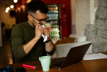 Portrait of angry businessman working on laptop. Exhausted worried businessman working in the office