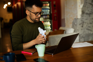 Portrait of angry businessman working on laptop. Exhausted worried businessman working in the office