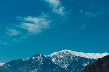Fototapeta na wymiar Clouds above the snow covered mountains in Manali, Himachal Pradesh, India
