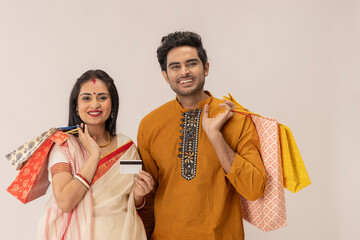 A HAPPY COUPLE IN TRADITIONAL CLOTHING STANDING AFTER SHOPPING	