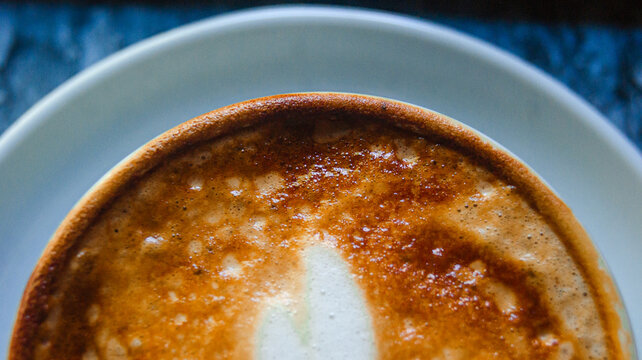 Top shot of coffee cup. Great colors combined with a great coffee design and shape. Detailed background.