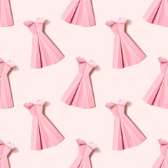 Origami paper background with pink dresses on pink background. Handmadepink dresses backdrop. Origami composition. Paper craft.