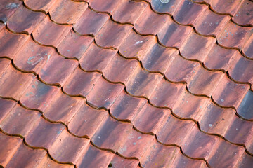 Background of red roof made of old tiles. In diagonal composition.