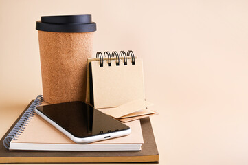 Black mobile smart phone mockup and stationery made from recycled materials, eco friendly concentrator, takeaway coffee mug. For design, presentation or portfolio layouts. Minimal mockup style. 