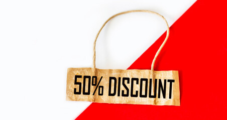 Label with a 50 percent discount sign on a white and red background.