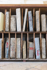 Obraz na płótnie Canvas Ancient stone books on bookshelves. Education and knowledge. Archive