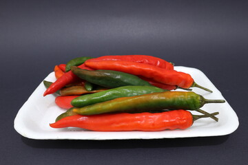 green and red chilies on a plate