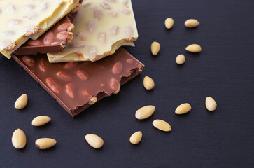 white and milk chocolate bars with almonds inside and sprinkled mandel