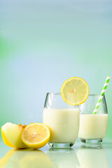  glasses with melon juice with milk and Sicilian lemon on reflective surface
