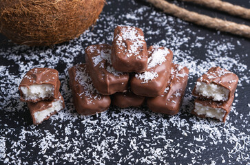 chocolate bars with coconut filling sprinkled with coconut flakes