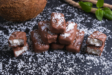 chocolate bars with coconut filling sprinkled with coconut flakes