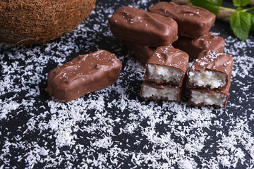 chocolate bars with coconut filling sprinkled with coconut flakes