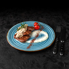 Beef medallions with sauce. Copy space, selective focus