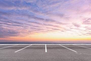 Empty parking lot against beautiful sunset sky.