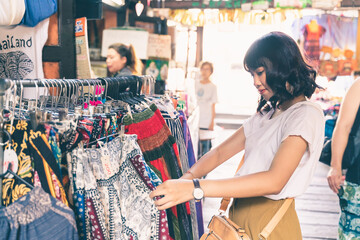 Asian young woman shopping at street market in bangkok, Thailand.