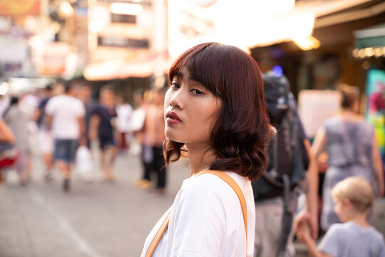 Portrait of Asian young woman on Khao San Road in Bangkok, Thailand.