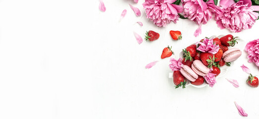 Beautiful Pink Peony flowers sweet strawberry and macaron cookies dessert, on a white background....